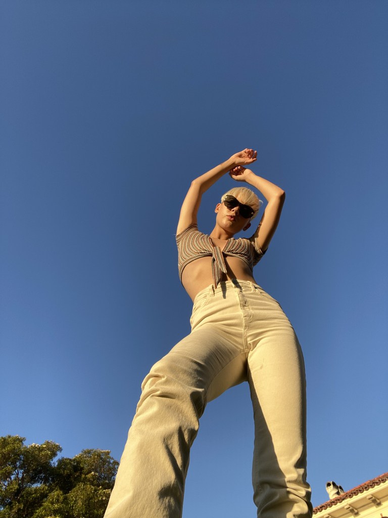 Chelsey Boll strikes a pose with her arms above her head. This pose is not as flattering as the photo on the right, though the differences are subtle.